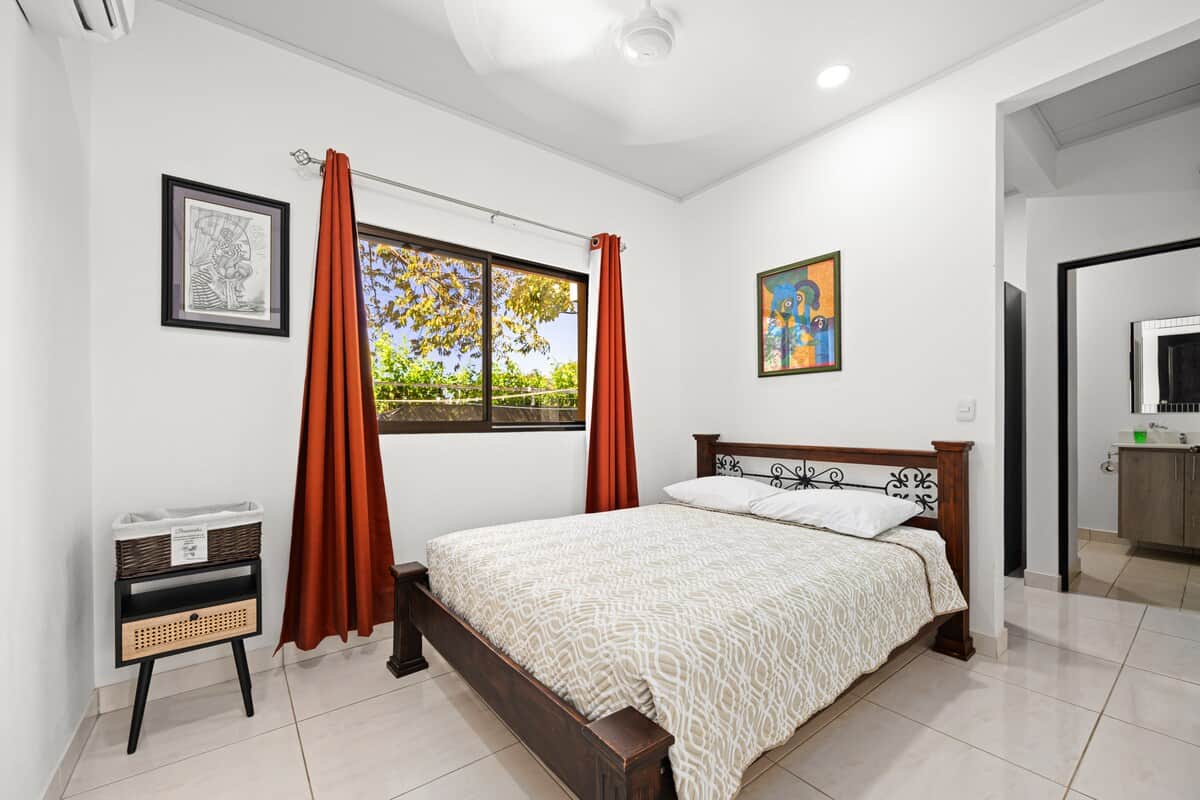 Master bedroom with air conditioning and a comfortable bed.