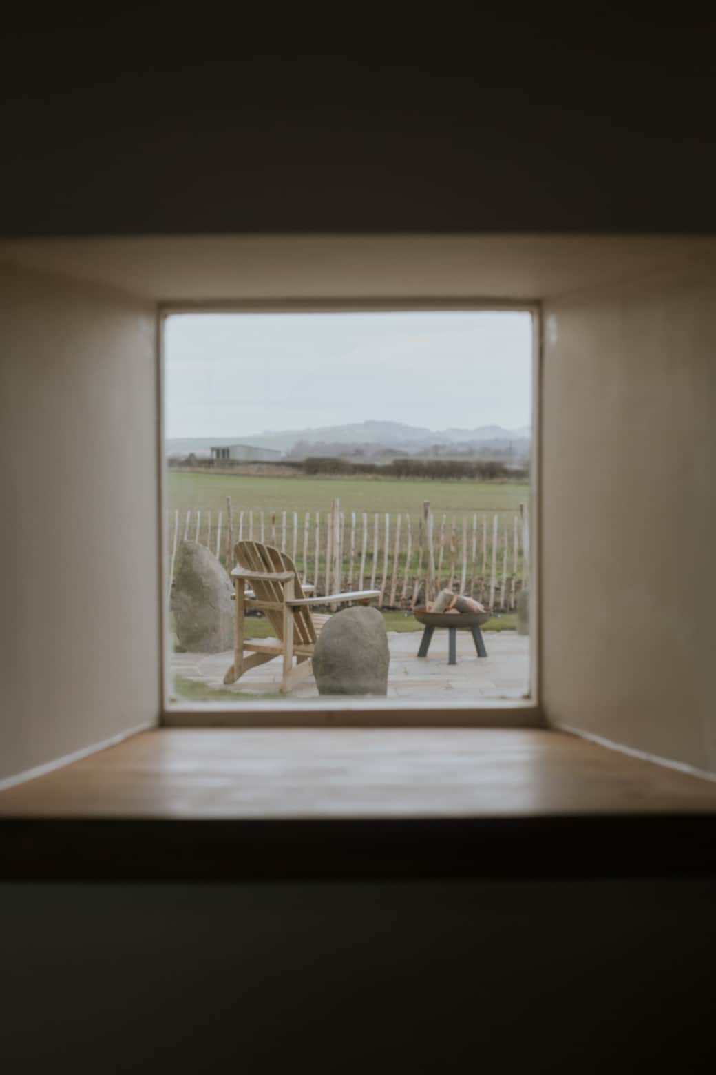 Little pictire window overlooking garden and fields