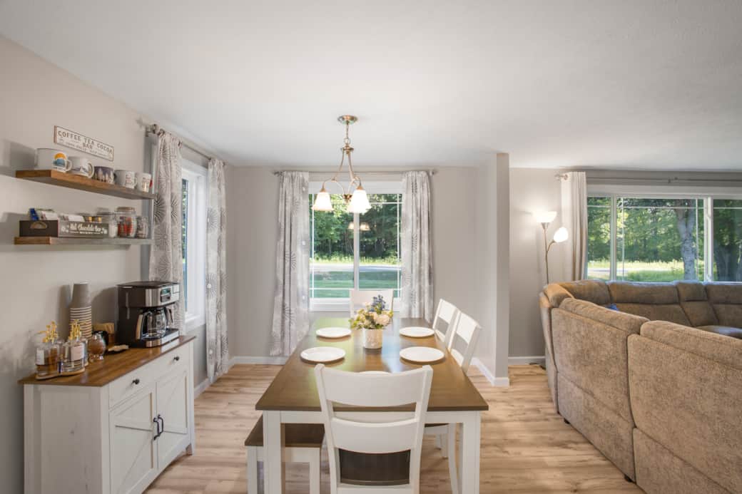 Bright, open living and dining space with cozy seating, coffee bar and room to gather.