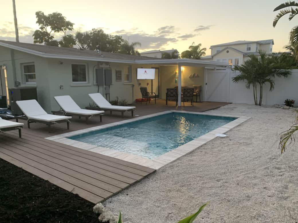 Pool with outdoor dining area and TV