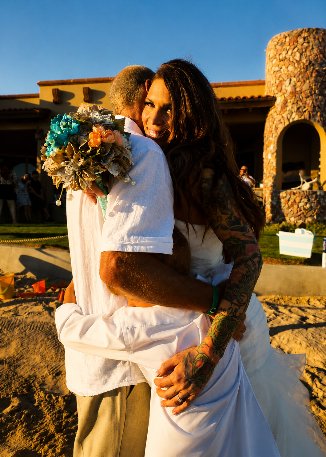 Bride and groom beach embrace