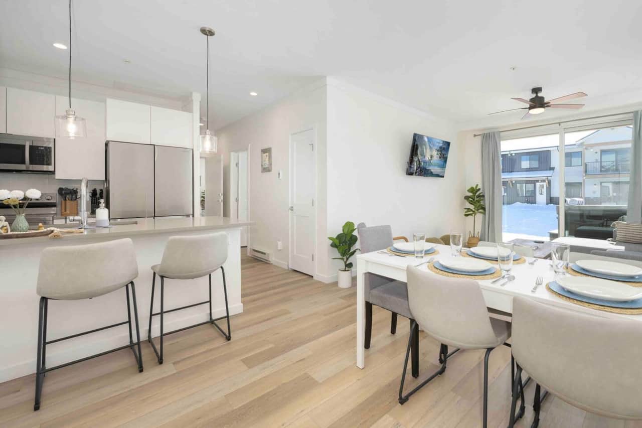 Guest can easily dine together when the table is expanded to seat 6 as shown (table will be downsized for 4 guest upon arrival).  2 extra gray chairs can be found in office nook and in front coat closet.