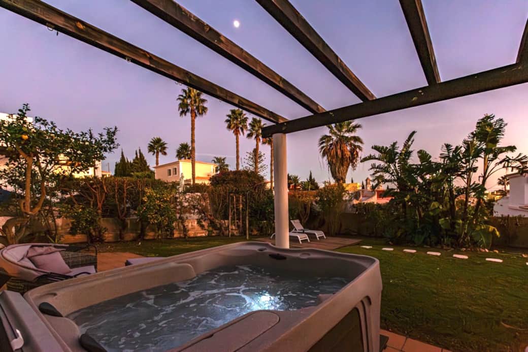 Enjoy glorious sunset colours and garden views from the hot tub.