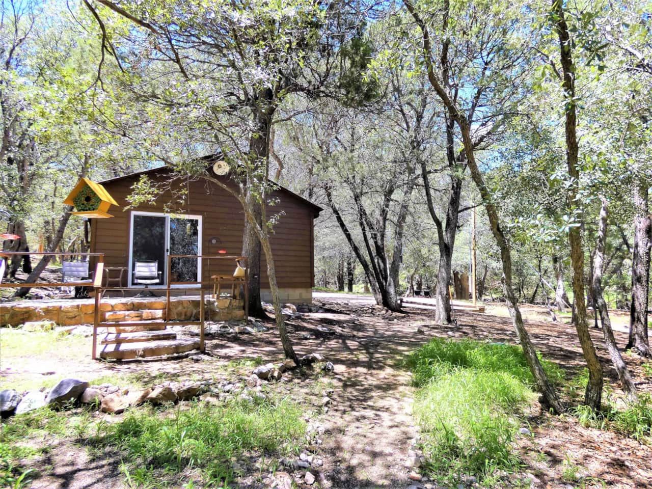 Private Patio area with seating, tables and bird feeders included.
