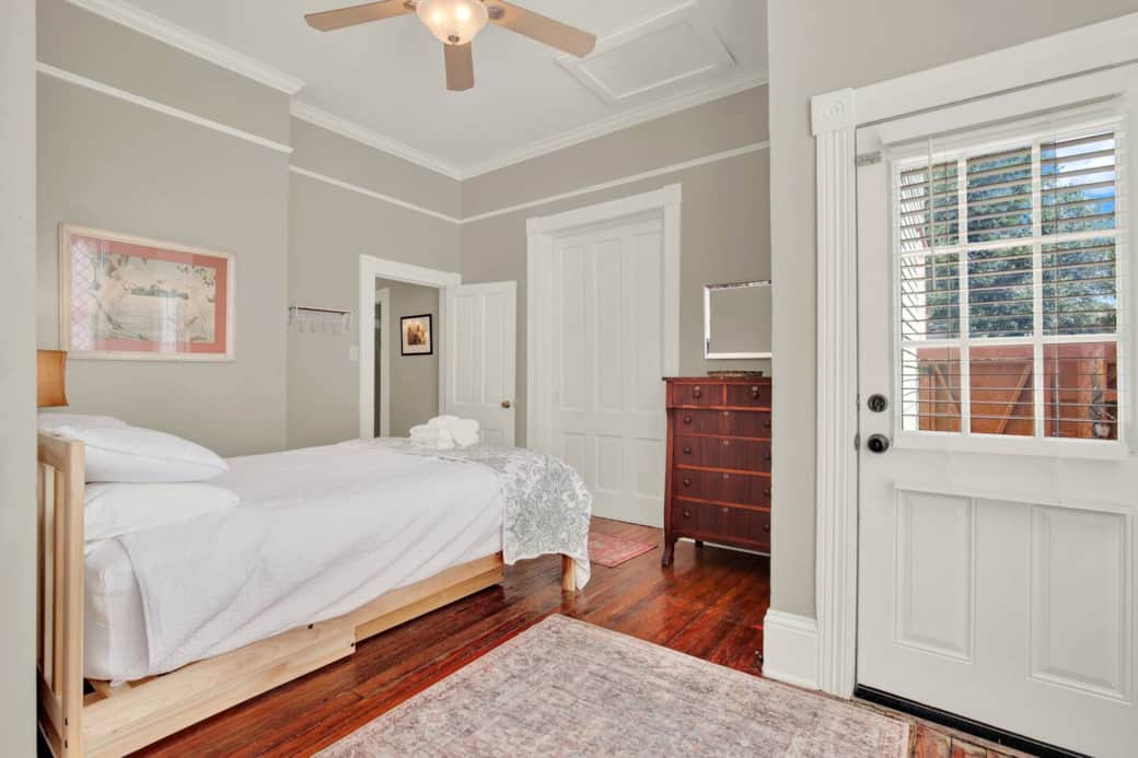 Queen bed with a ceiling fan to keep you cool, plus extra storage available in the dresser drawers and armoire. Side exit into the backyard.