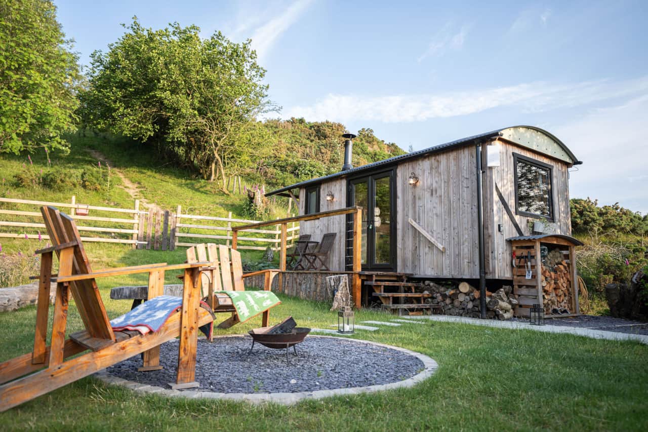 Serene hut with outdoor seating and scenic views.