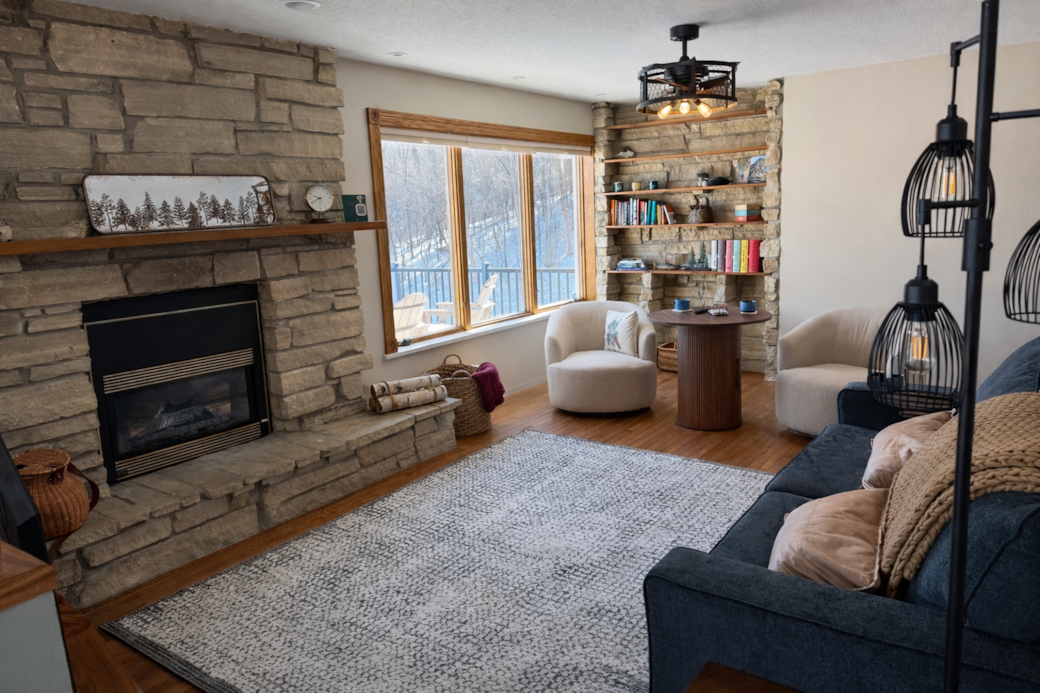 Gathering space with fireplace, television, games, and open to dining and kitchen.