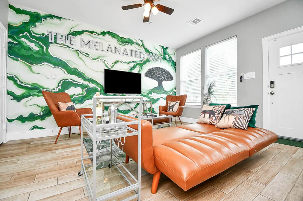 The Melanated Way Living Room with 75 inch TV and sofa bed The Melanated Way Living Room with 75 inch TV and sofa bed