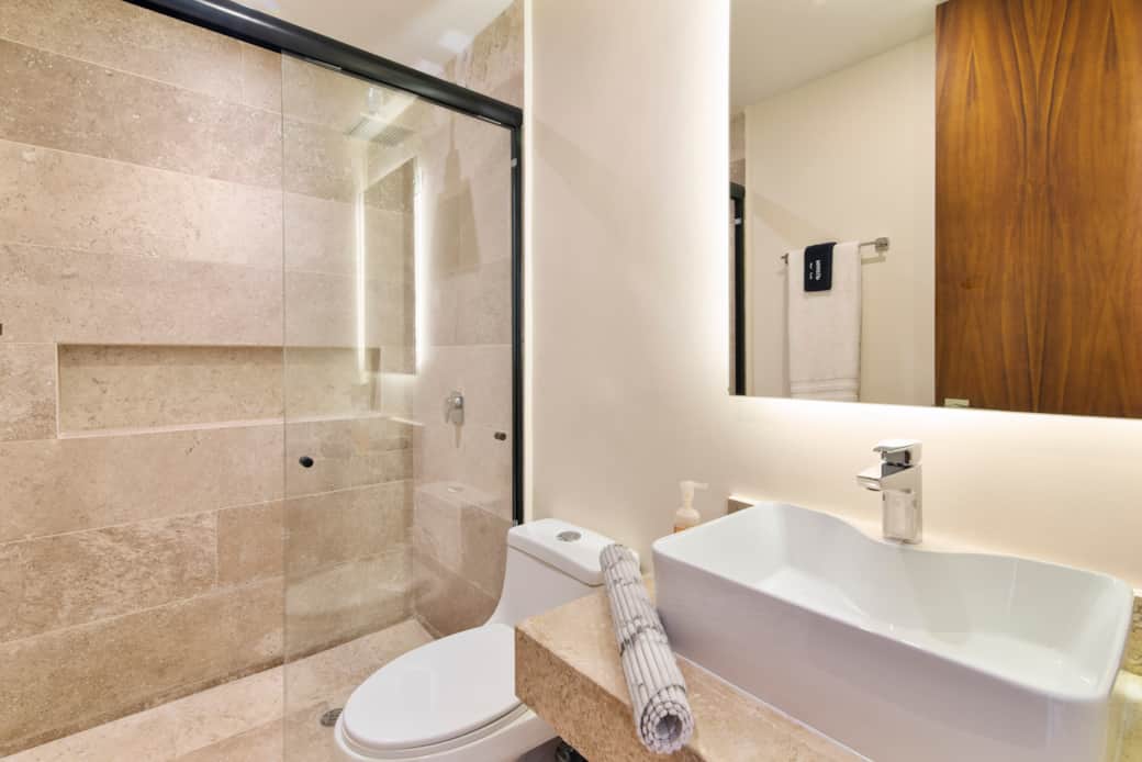 Bathroom with modern backlit mirrors and handy hooks for practical luxury. Bathroom with modern backlit mirrors and handy hooks for practical luxury.