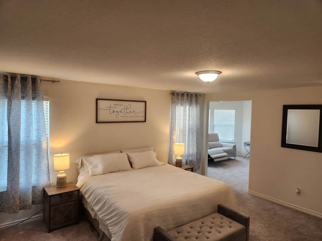 Large primary bedroom with private TV sitting area and ensuite. Large primary bedroom with private TV sitting area and ensuite.