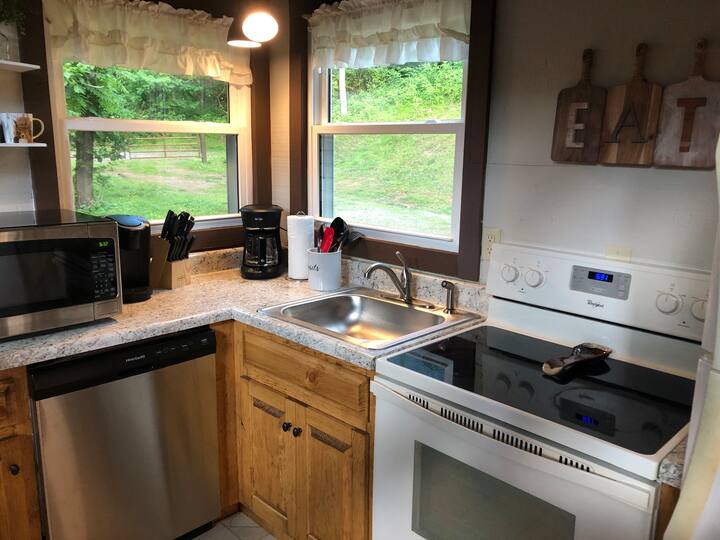 Cook, eat, repeat: This kitchen is complete with cookware, dishes, and utensils.