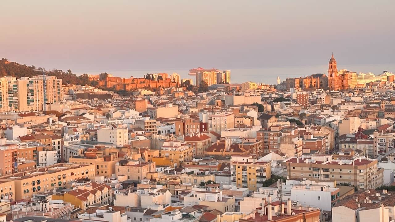 Sunset panoramic view of Málaga’s historic center, Alcazaba and Cathedral seen from our apartment.