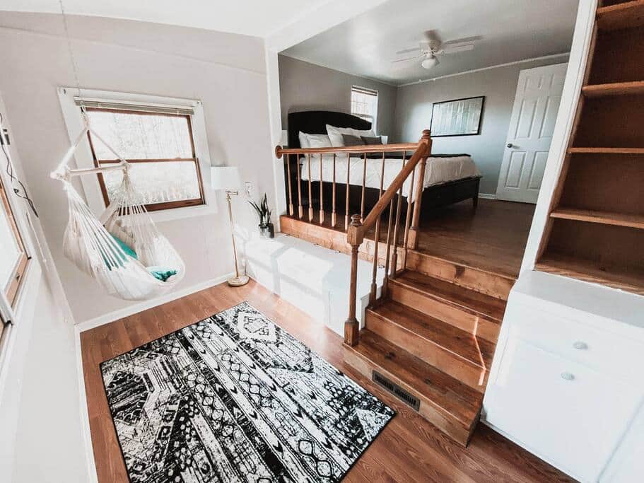 The bottom part of the main bedroom where there is a hanging chair to relax in.