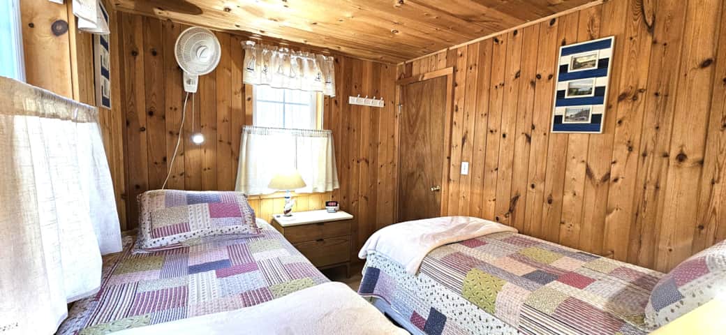 Second bedroom with closet, room darkening shades, heater and ceiling fan. 