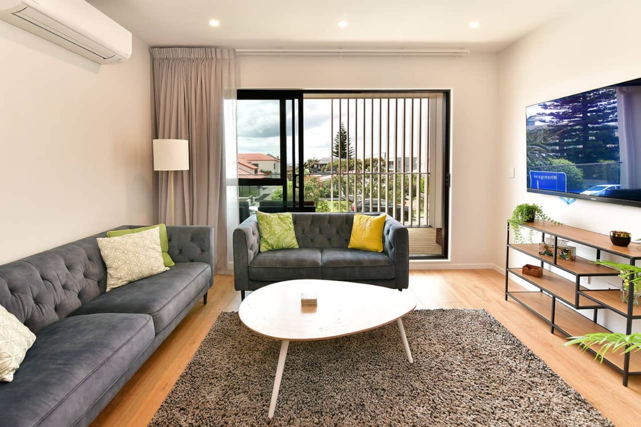 Lounge with comfortable couches, a large TV and nice views.