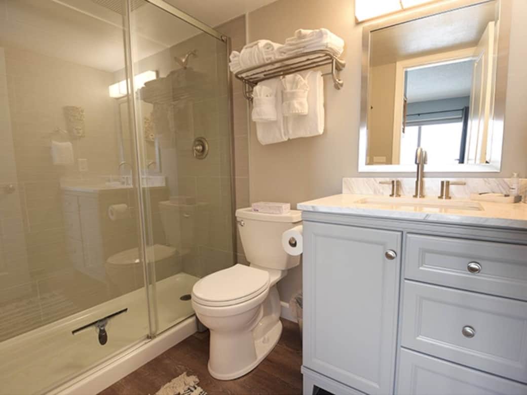 Bright and modern ensuite bath conveniently located off the downstairs bedroom — perfect for added privacy and comfort. Bright and modern ensuite bath conveniently located off the downstairs bedroom — perfect for added privacy and comfort.