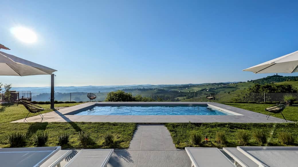 Panoramic view over the pool and hills from Villa Perla