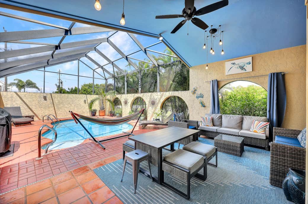 Heated Saltwater Pool/Lanai, lounge chairs, hammock, grill, TV/Sound bar, wine fridge, sink, dining.
