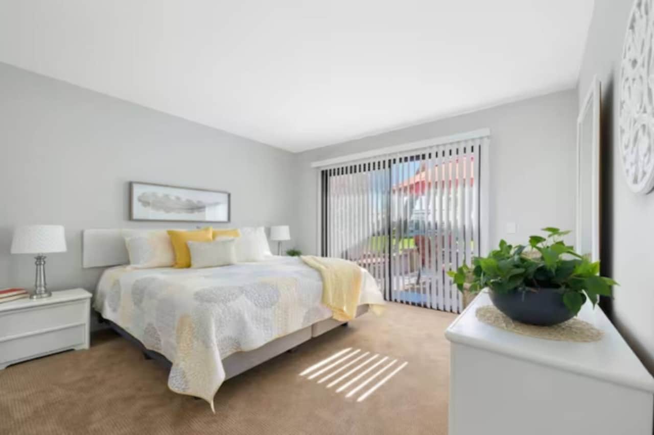 [Primary Bedroom] King Bed with Easy Access Sliding Doors to Outdoor Balcony.