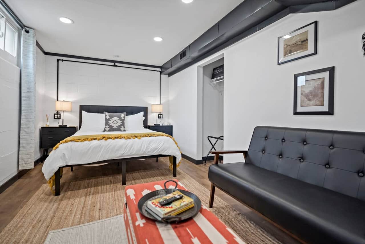 Downstairs Bedroom: Chic decor meets comfort—relax on the loveseat or enjoy a movie night!