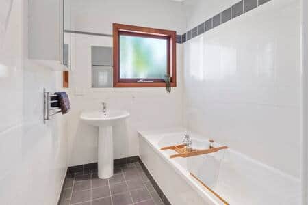 Main bathroom with bath and shower facility.
