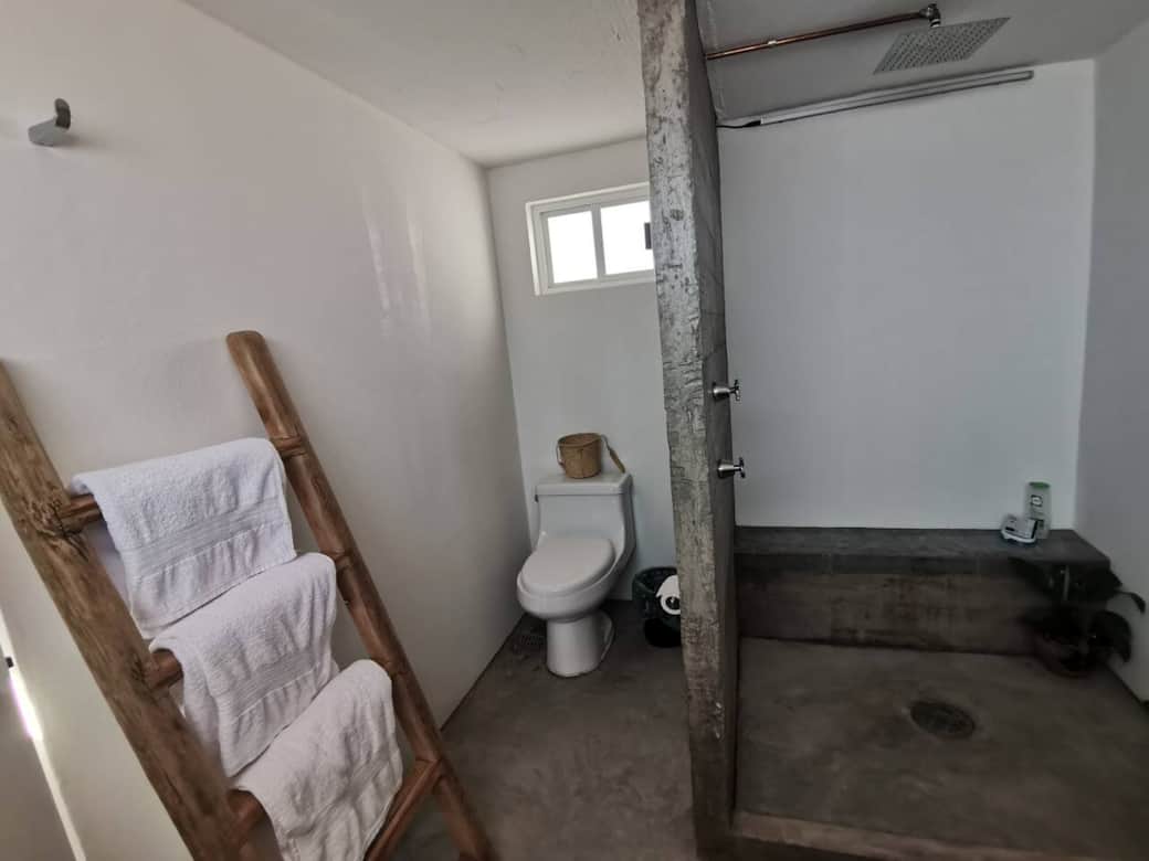 El baño es un espacio de concreto y agua. En el encontrarás shampoo, jabón de manos, jabón de ducha, toallas y secadora. 