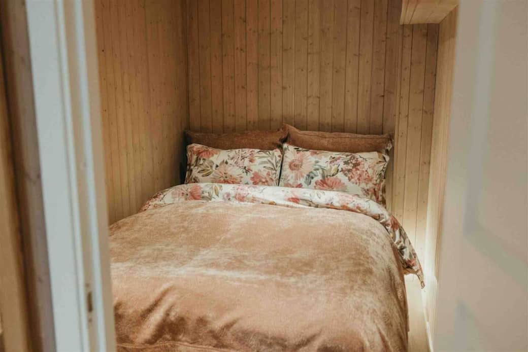 The smaller bedroom with delicate satin bet linens 