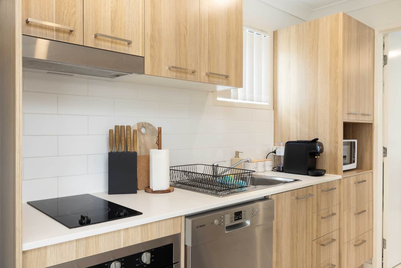 Kitchen: Sleek kitchen with ample storage, modern appliances 