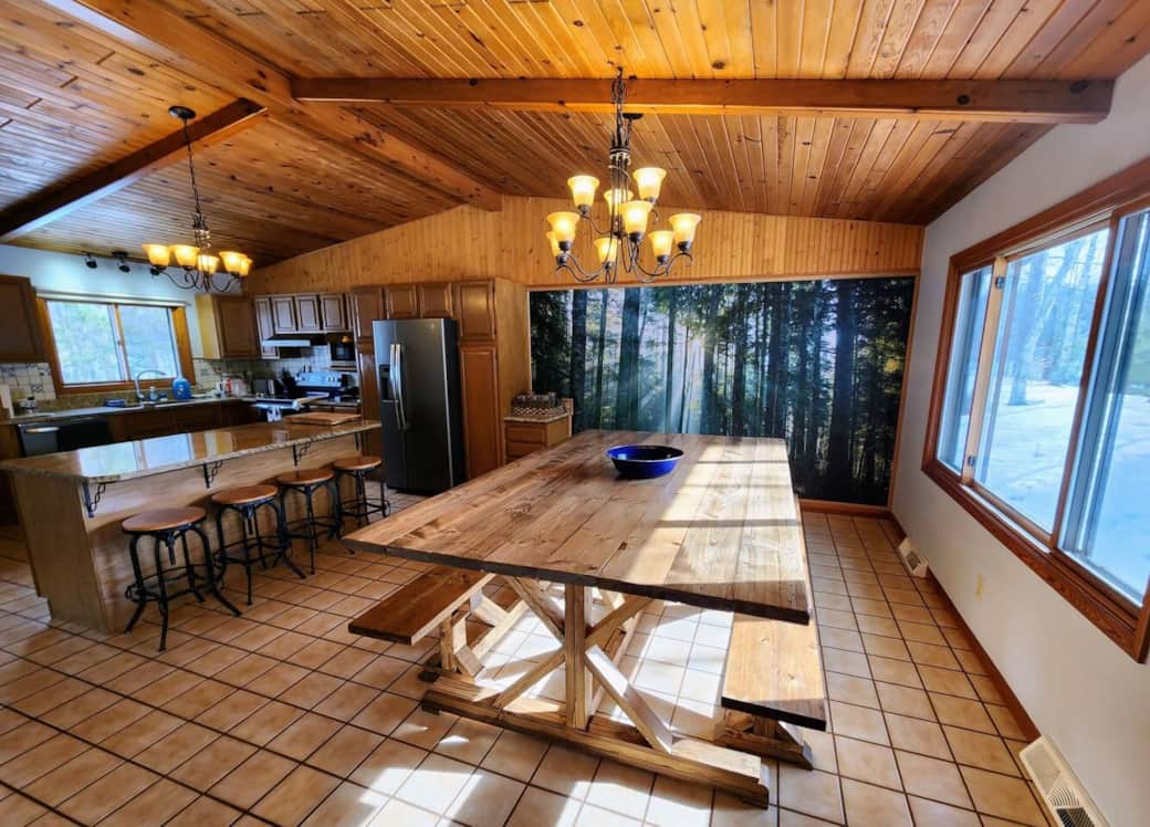 Open kitchen with island bar and huge custom table 