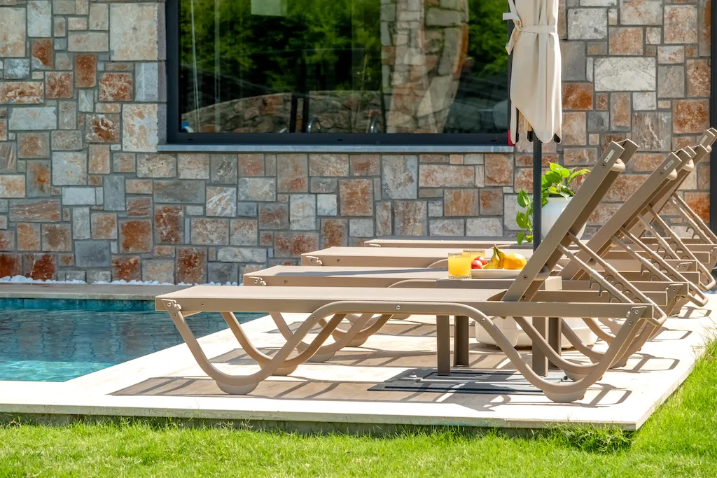 Lounge chairs by the pool with a stone wall in the background, Villa Palmiye B, Gocek