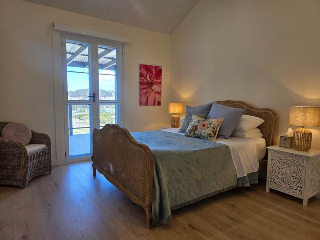 Front bedroom, queen bed opens via french doors onto front deck. Front bedroom, queen bed opens via french doors onto front deck.