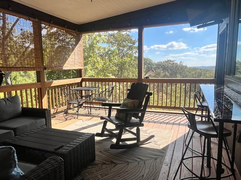 Screened outdoor living room with TV & pass through window to kitchen