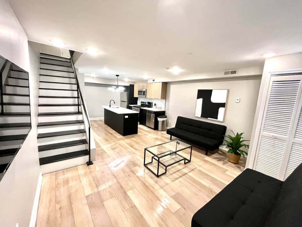 Living room with two futon sofa beds and flat screen tv.
Bi-level going upstairs to bathroom and 2 bedrooms.
