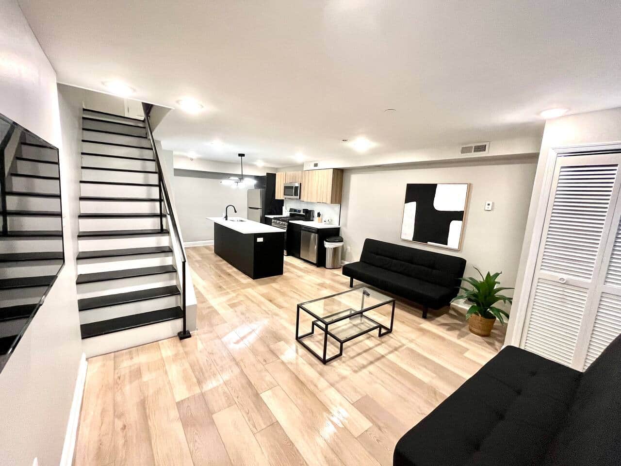 Living room with two futon sofa beds and flat screen tv.
Bi-level going upstairs to bathroom and 2 bedrooms.