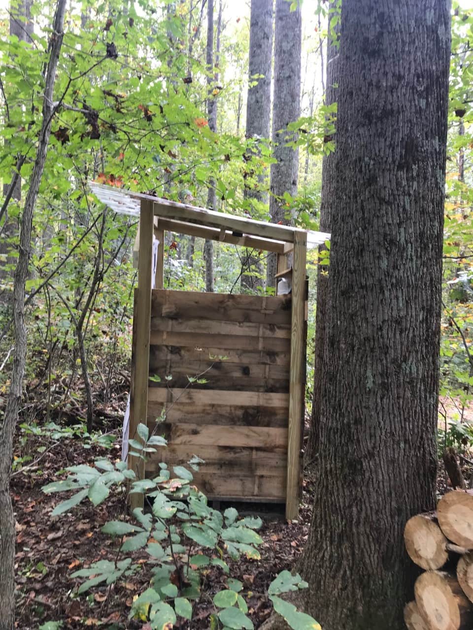 A covered changing area includes a portable toilet using biobags