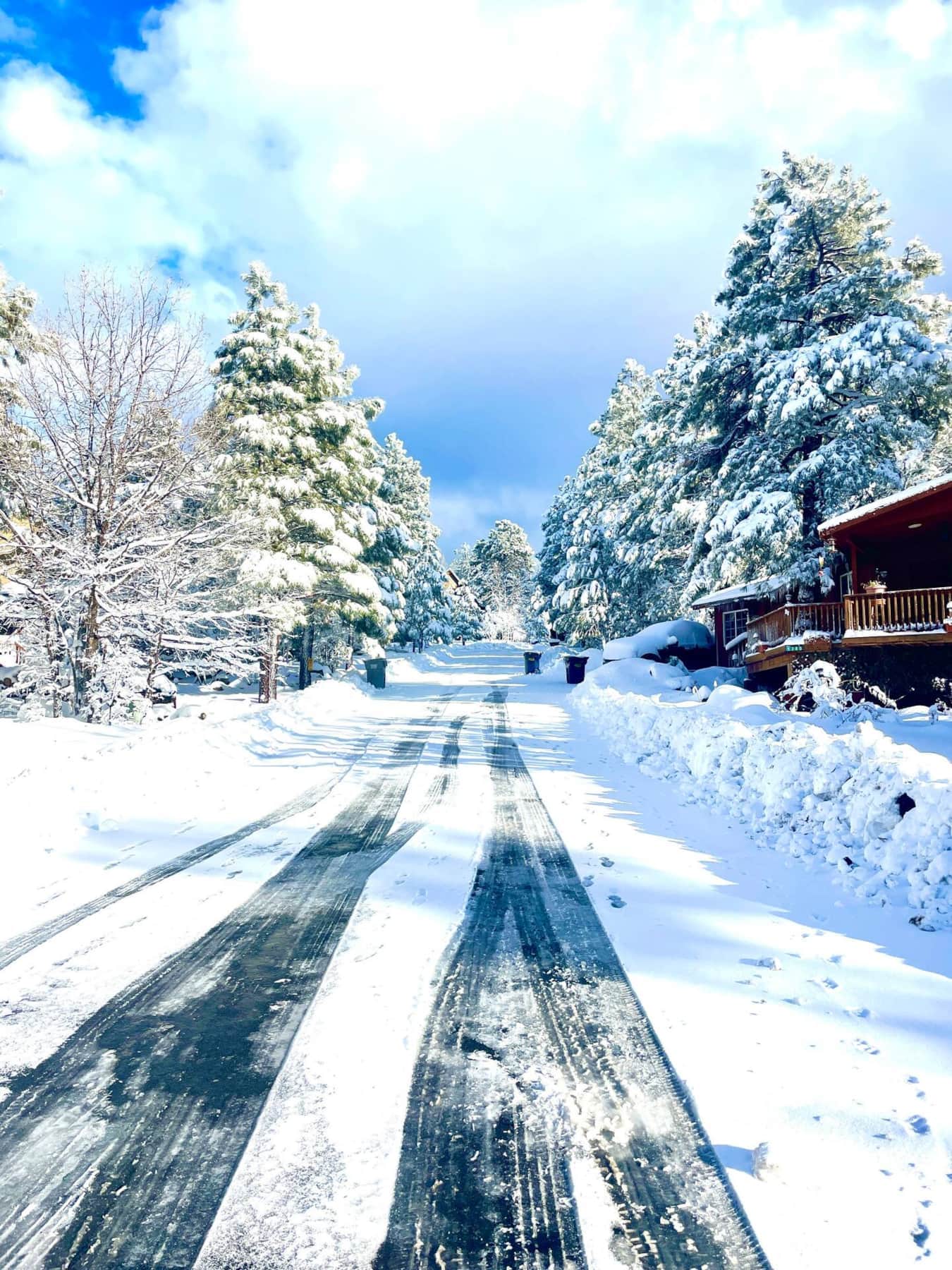 Snowy mountain road near cabin in winter