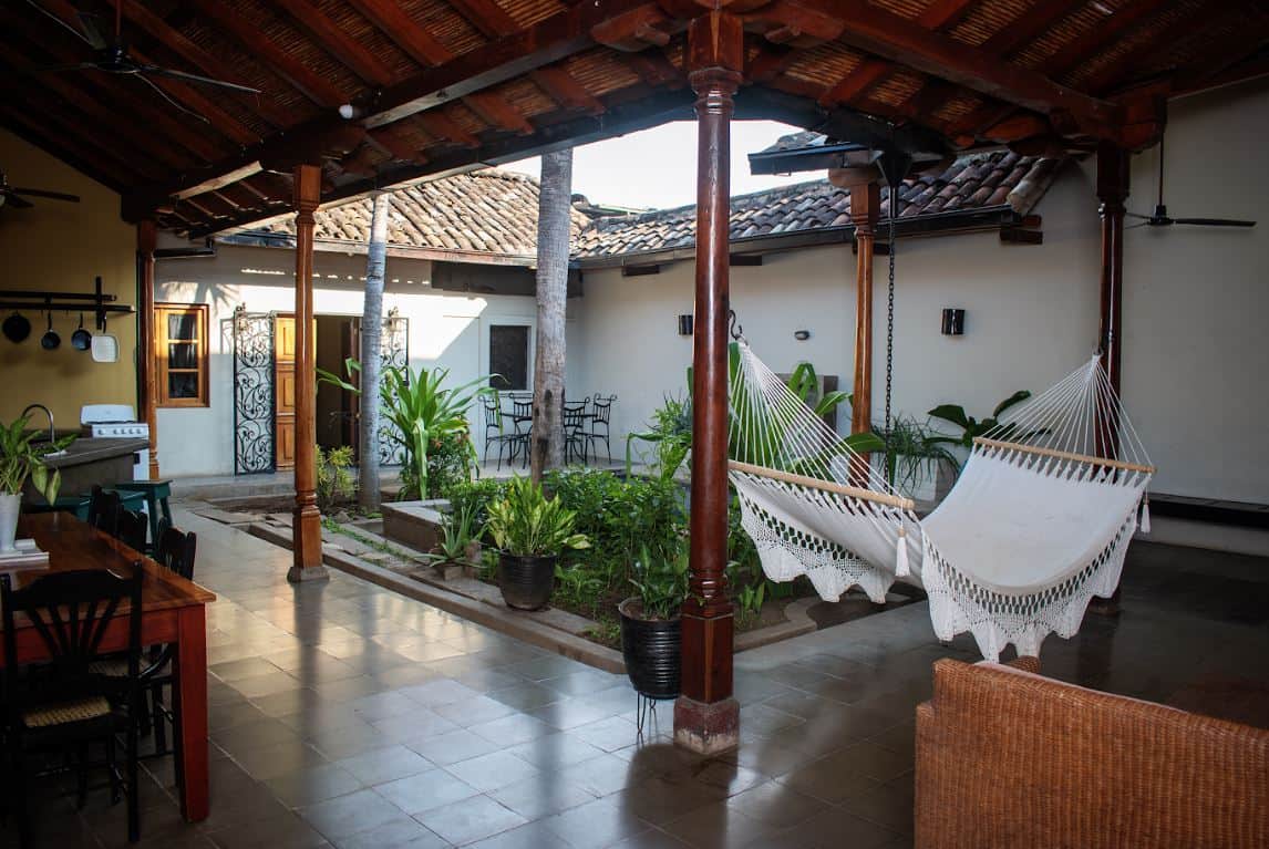Hammocks and tropical garden in the arcaded courtyard of a restored colonial home in Granada