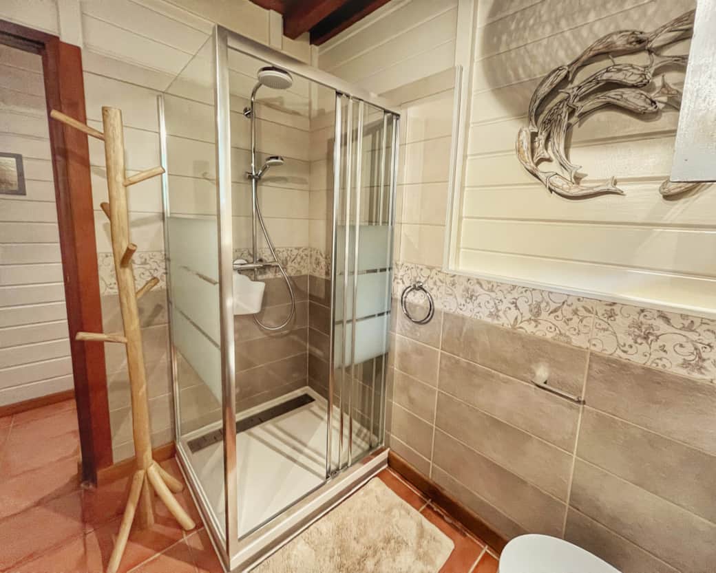 Bathroom 2 - Ground floor. Shower, toilet, 2 sinks, hairdryer, mirror, towels.