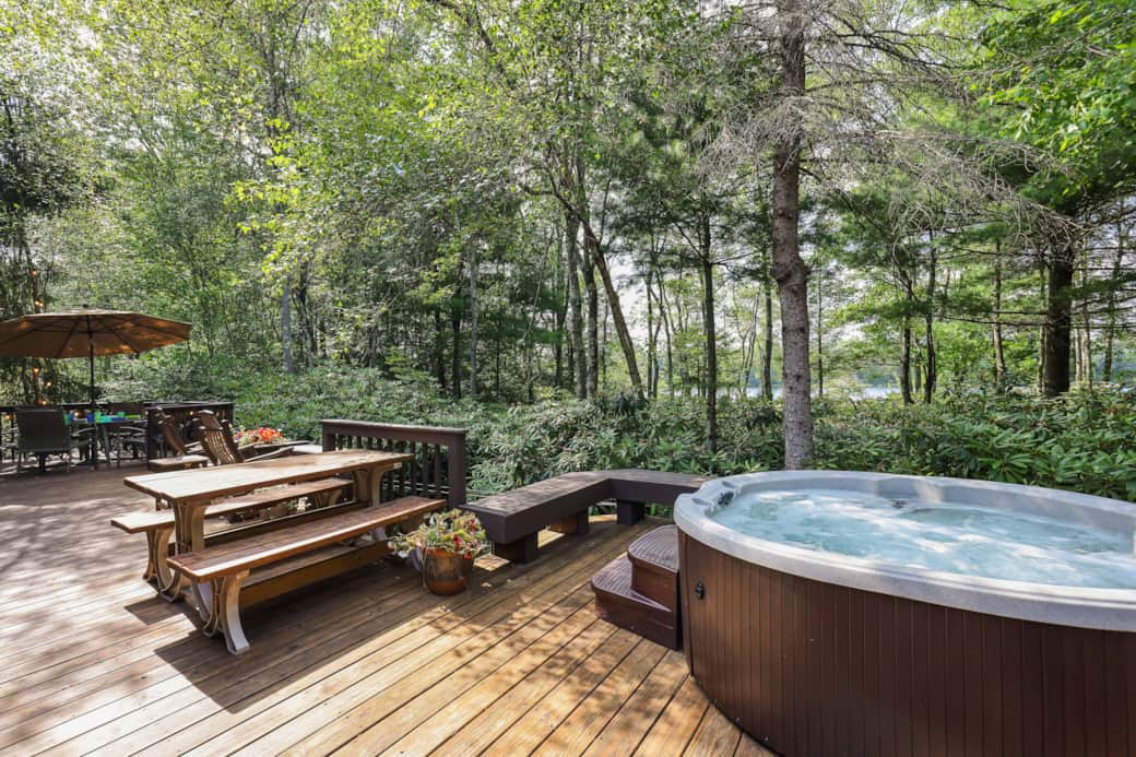 Expansive deck with hot tub picnic table dining table and grill