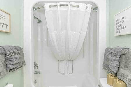 View of bathroom featuring shower/tub combo!