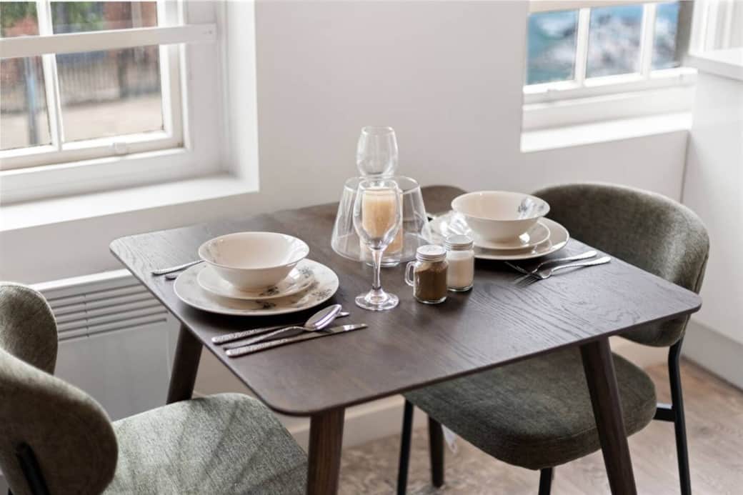 An intimate dining space set for two, perfect for relaxed breakfasts or cosy evening meals. An intimate dining space set for two, perfect for relaxed breakfasts or cosy evening meals.