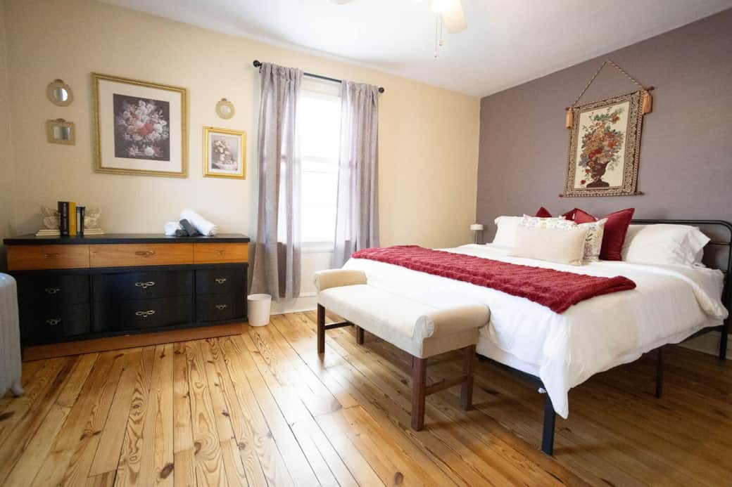 This stylish bedroom blends comfort with charm, featuring cozy bedding, vintage-inspired artwork, and a soft color palette. A peaceful retreat to rest and recharge.