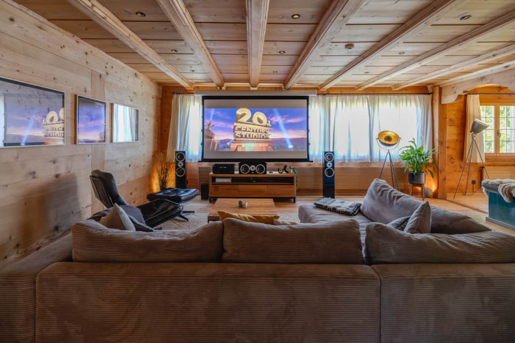 Large living room with mountain views, tiled stove, state-of-the-art home theater, gaming consoles