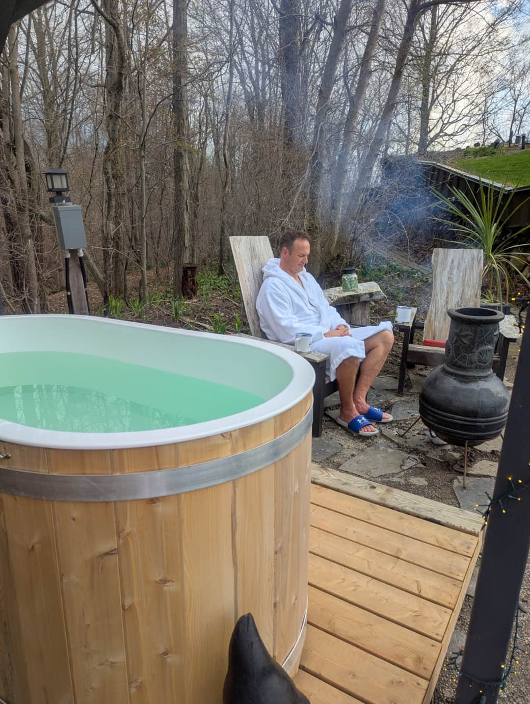 Cold plunge by Adirondack chairs and fire