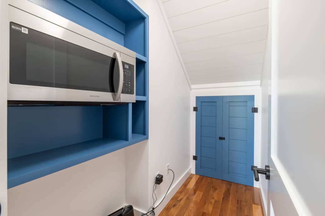 The pantry/storage closet contains the microwave. The locked owner's closet is pictured straight ahead.