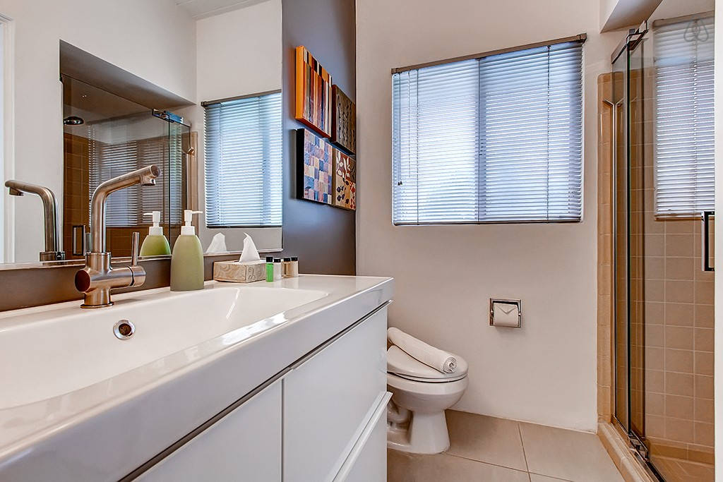 A clean bathroom with a shower, toilet, and sink