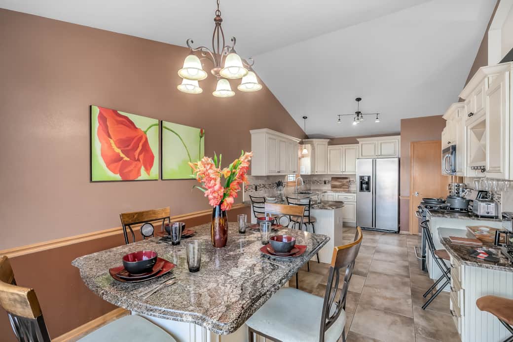 Dining table is bar height and can sit 6. Dinnerware for 10 is provided