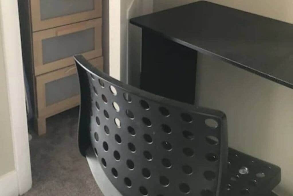 Storage for ironing board and iron, and extra linens; desk and chair. Storage for ironing board and iron, and extra linens; desk and chair.