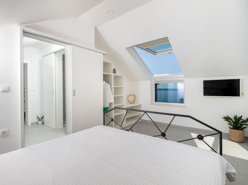 Wake to sea views & sunshine! West Bedroom with skylight, TV, and refreshing AC. Wake to sea views & sunshine! West Bedroom with skylight, TV, and refreshing AC.