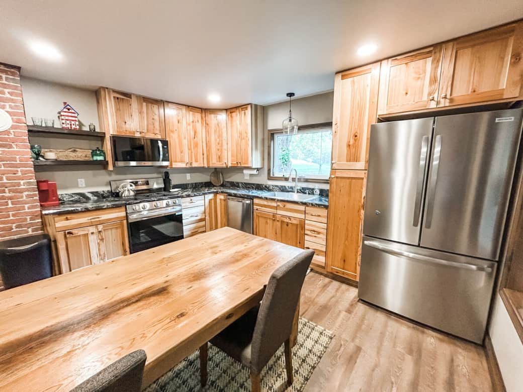 Enjoy modern appliances, generous counter space, and hickory cabinetry in this charming heart-of-the-home. Enjoy modern appliances, generous counter space, and hickory cabinetry in this charming heart-of-the-home.